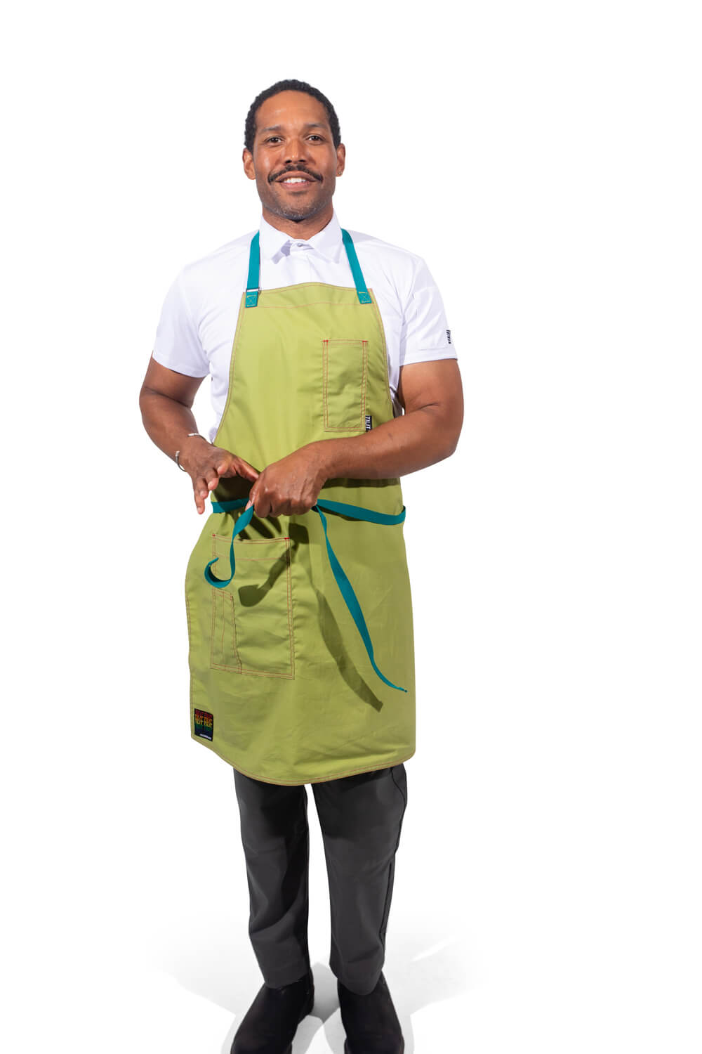 TILIT model wearing a green apron with teal accents straps