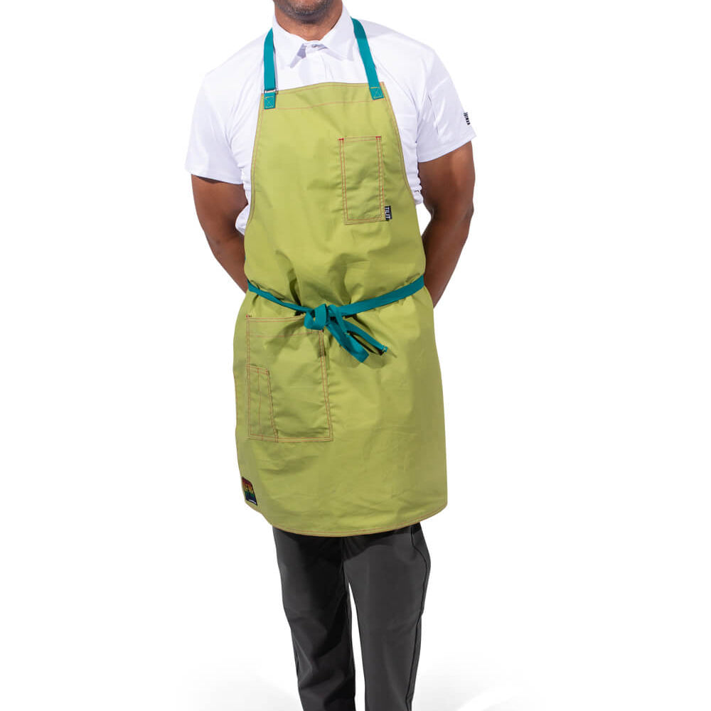 TILIT model wearing a green apron with teal accents straps