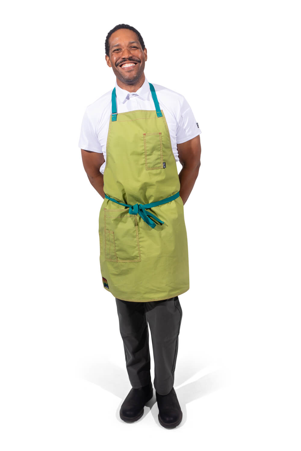 TILIT model wearing a green apron with teal accents straps