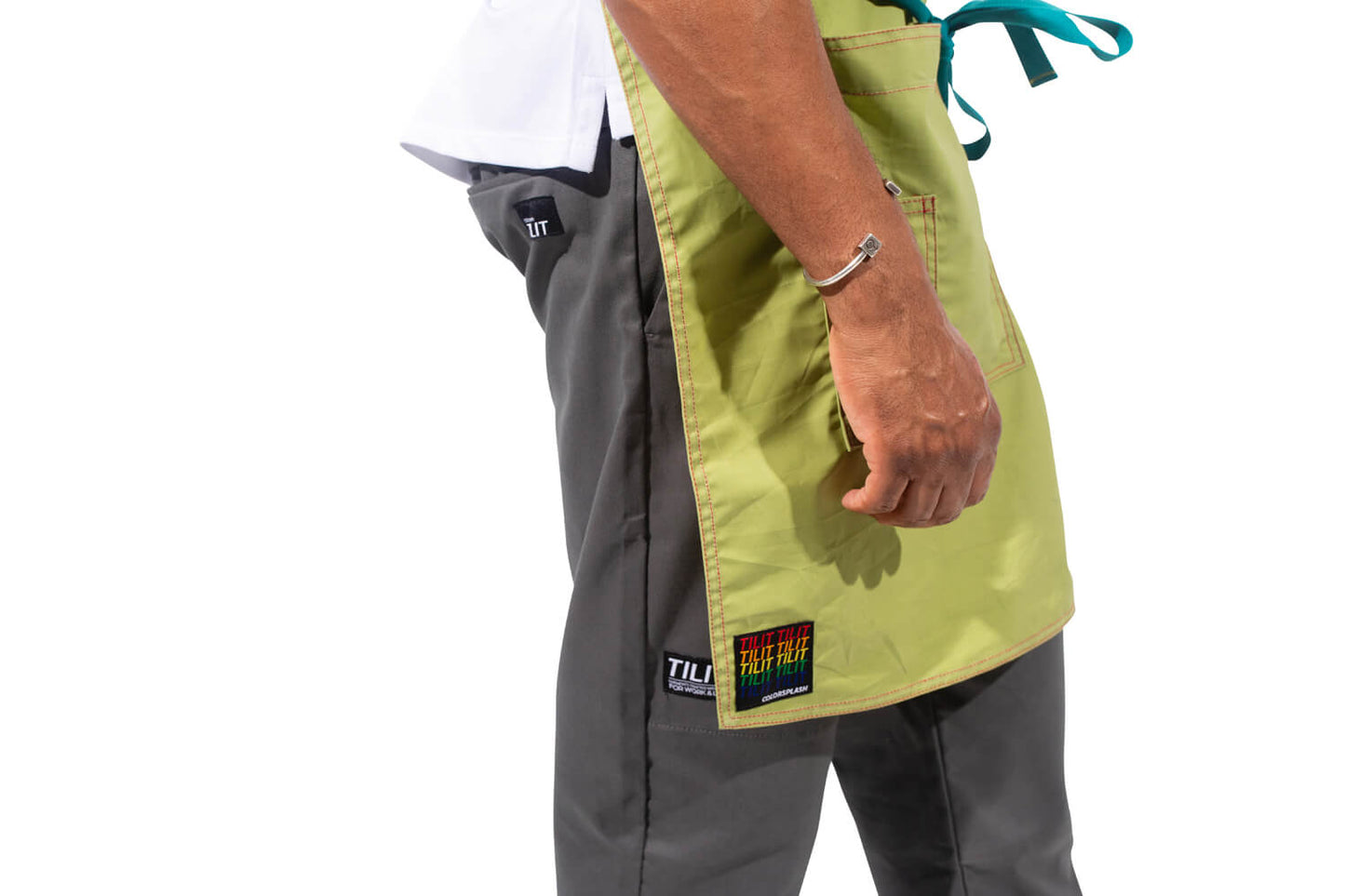 TILIT model wearing a green apron with teal accents straps