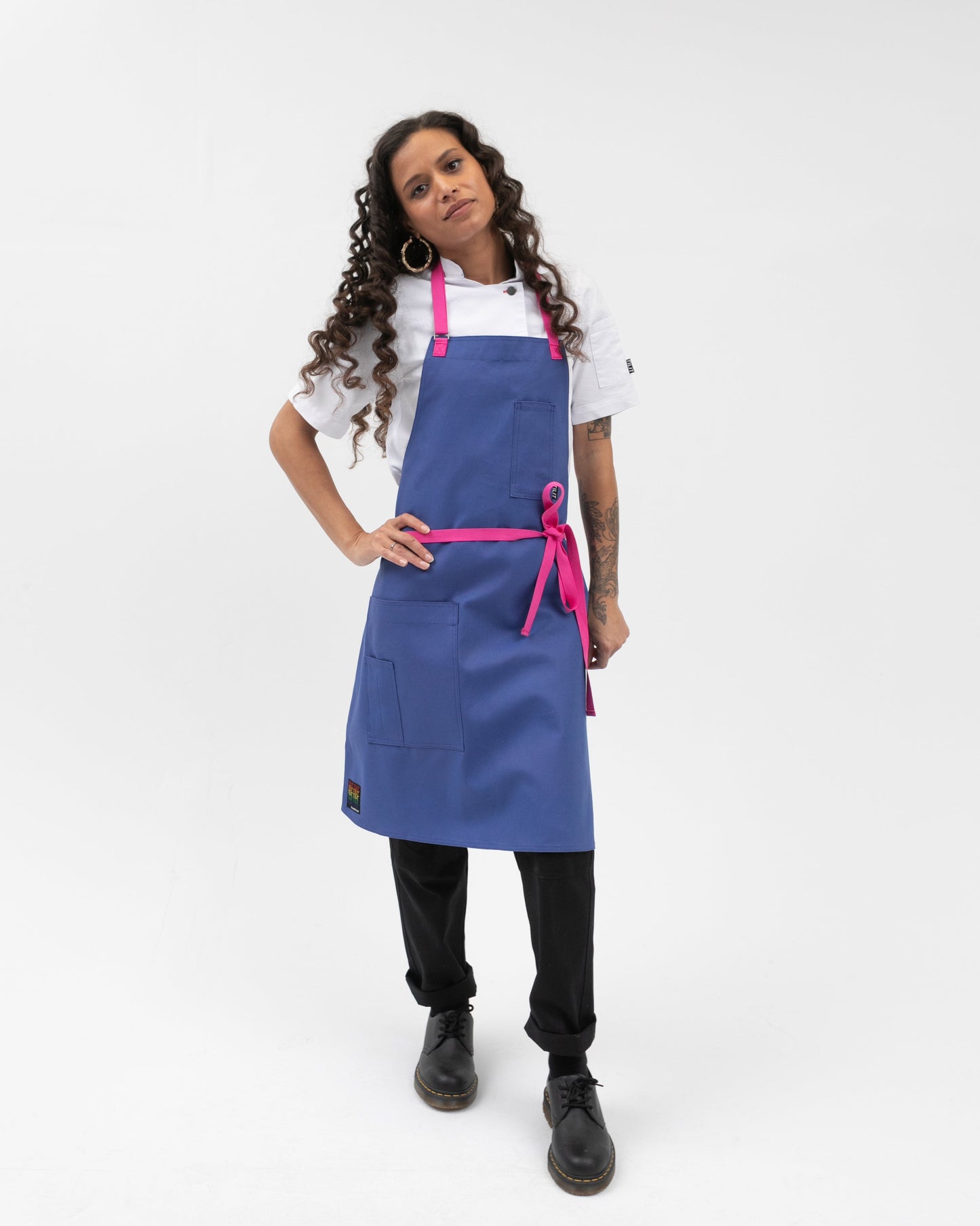 bib style apron in blue with pink straps