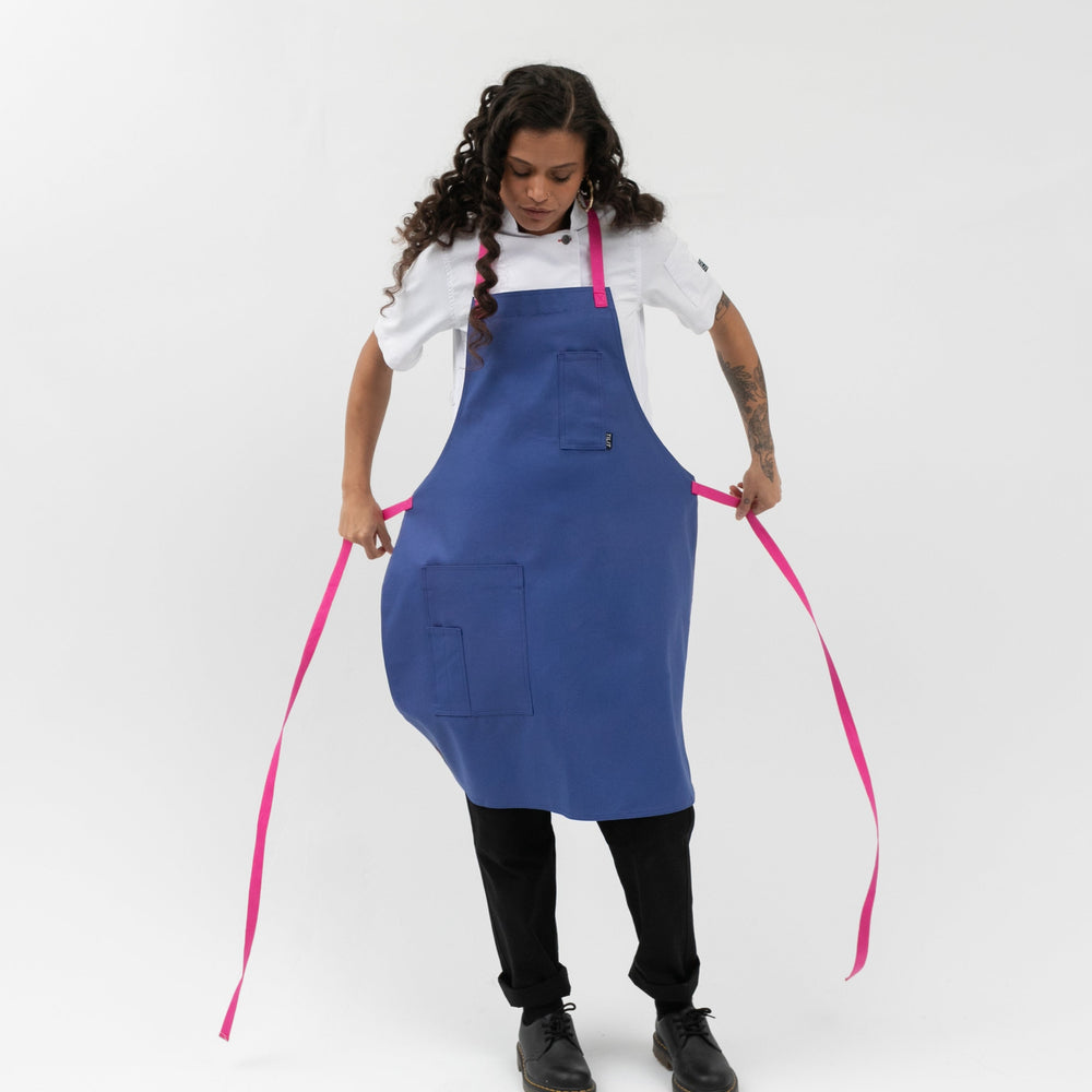 bib style apron in blue with pink straps