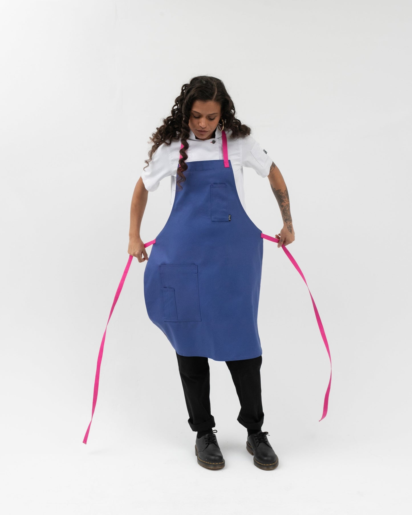 bib style apron in blue with pink straps