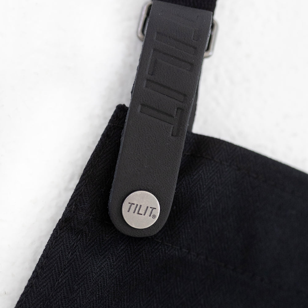 
                  
                    Black wax cotton apron 
                  
                