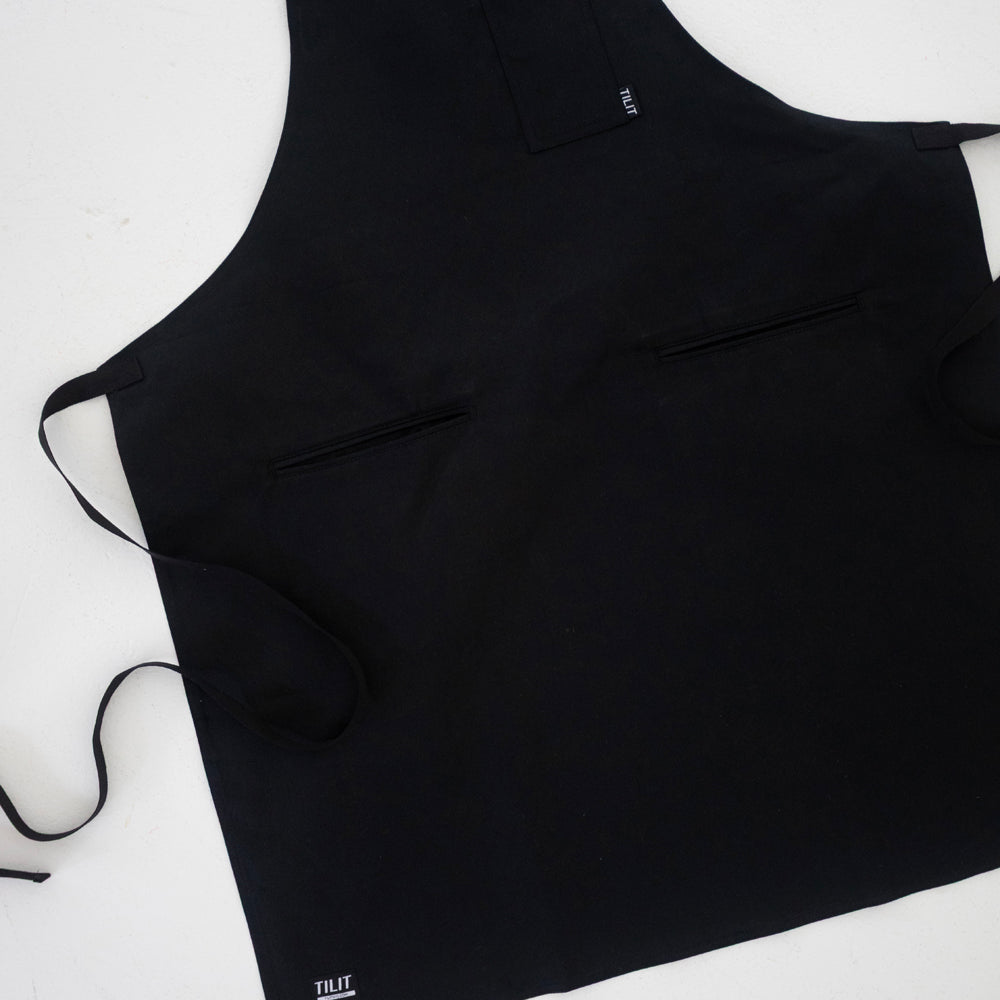 
                  
                    Black wax cotton apron 
                  
                