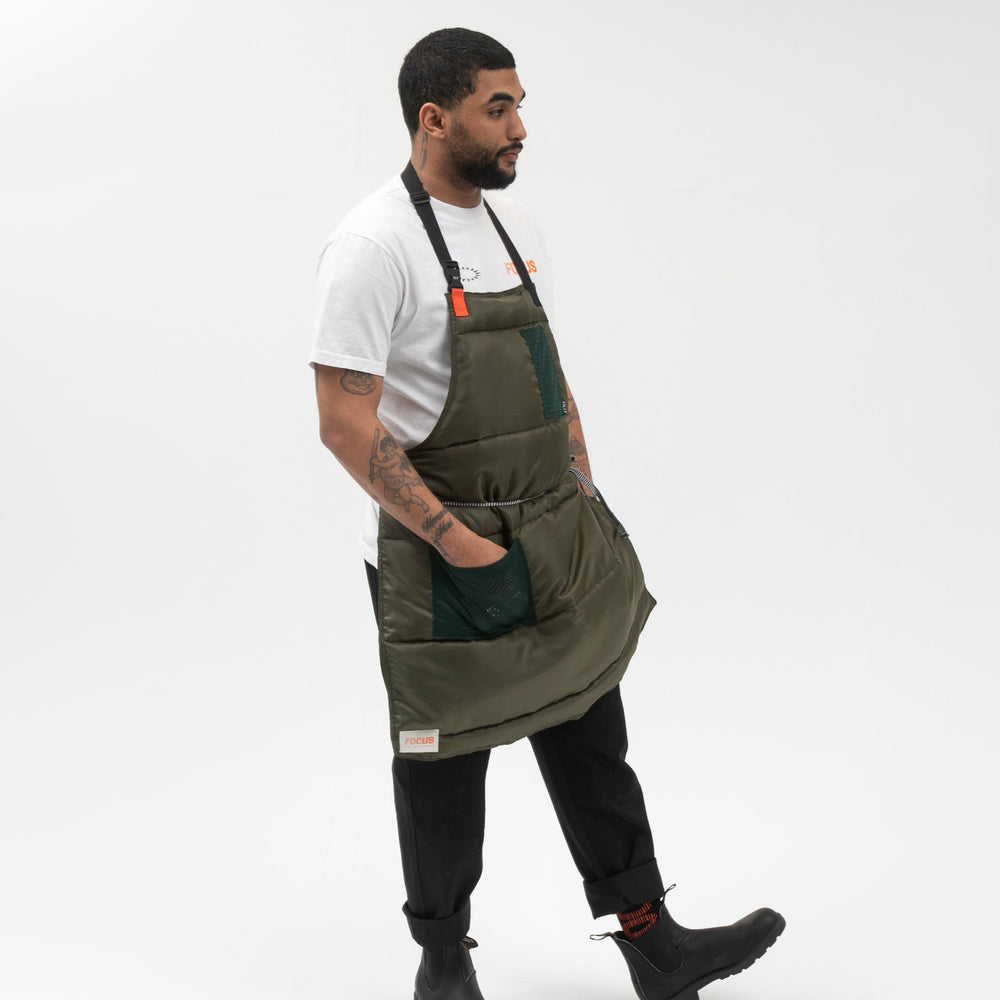 
                  
                    TILIT puffer apron in olive green
                  
                