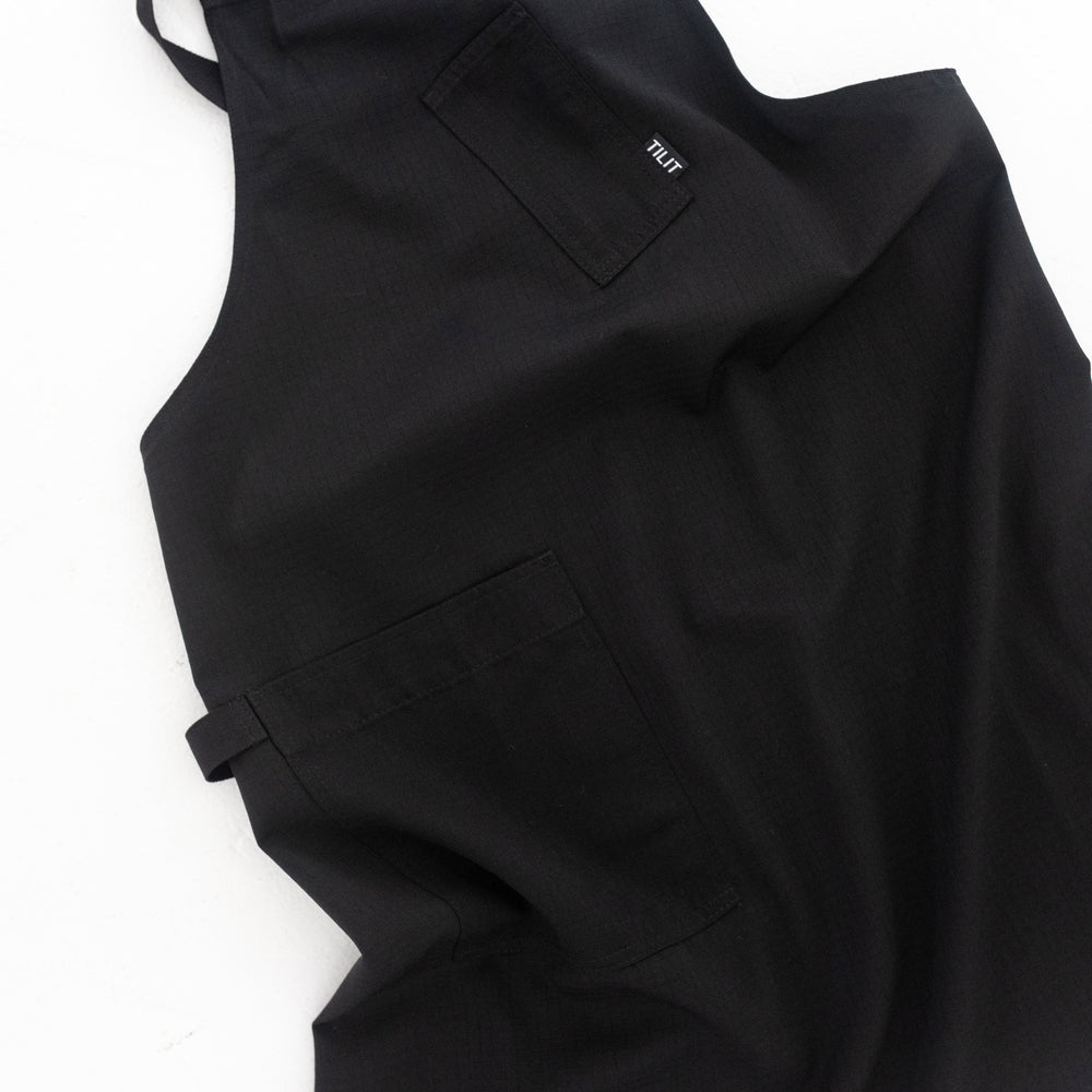 
                  
                    TILIT Supply Cross Back Apron in Black
                  
                