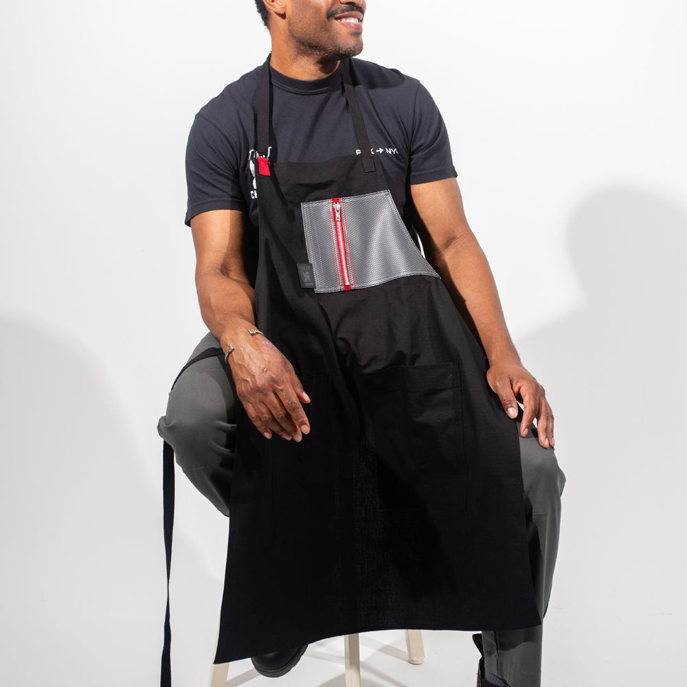 TILIT and Chrome collab apron with a chest and pocket. Chest pocket has a zipper closure