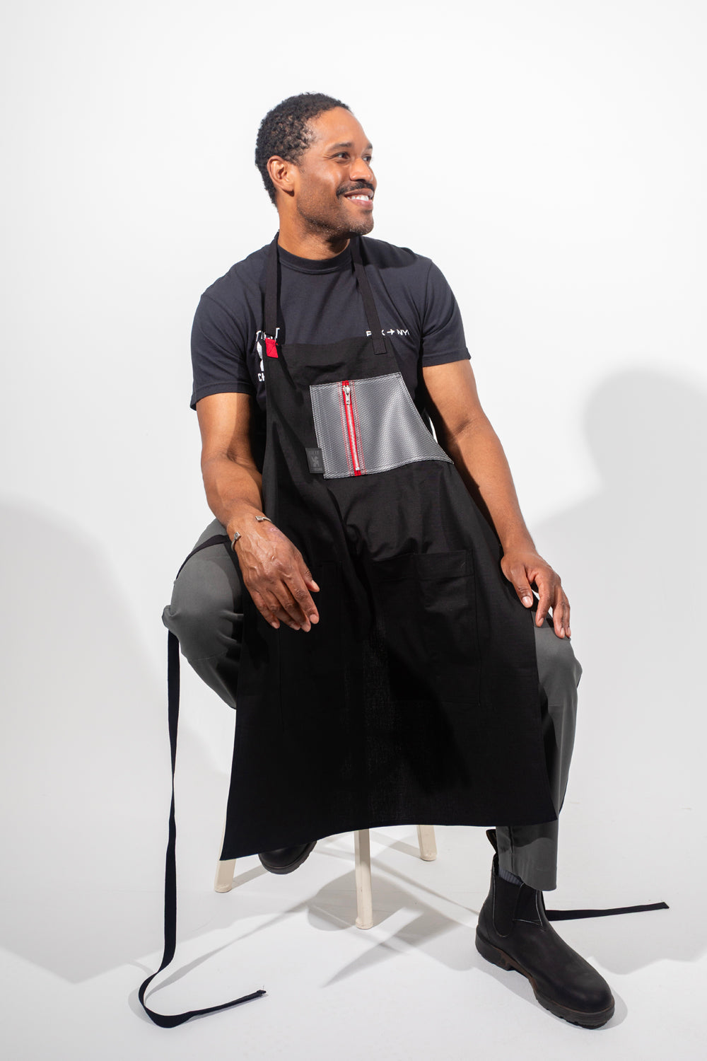 TILIT and Chrome collab apron with a chest and pocket. Chest pocket has a zipper closure