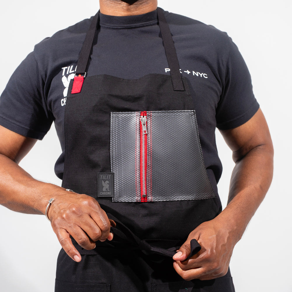 TILIT and Chrome collab apron with a chest and pocket. Chest pocket has a zipper closure