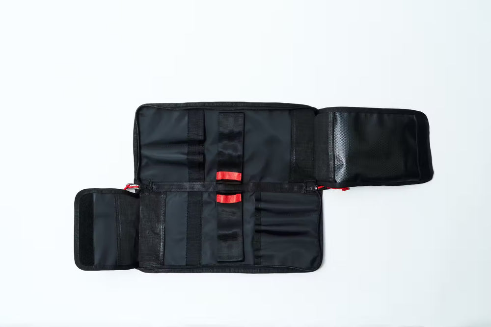
                  
                    Black Knife bag with red zippers on a white background
                  
                