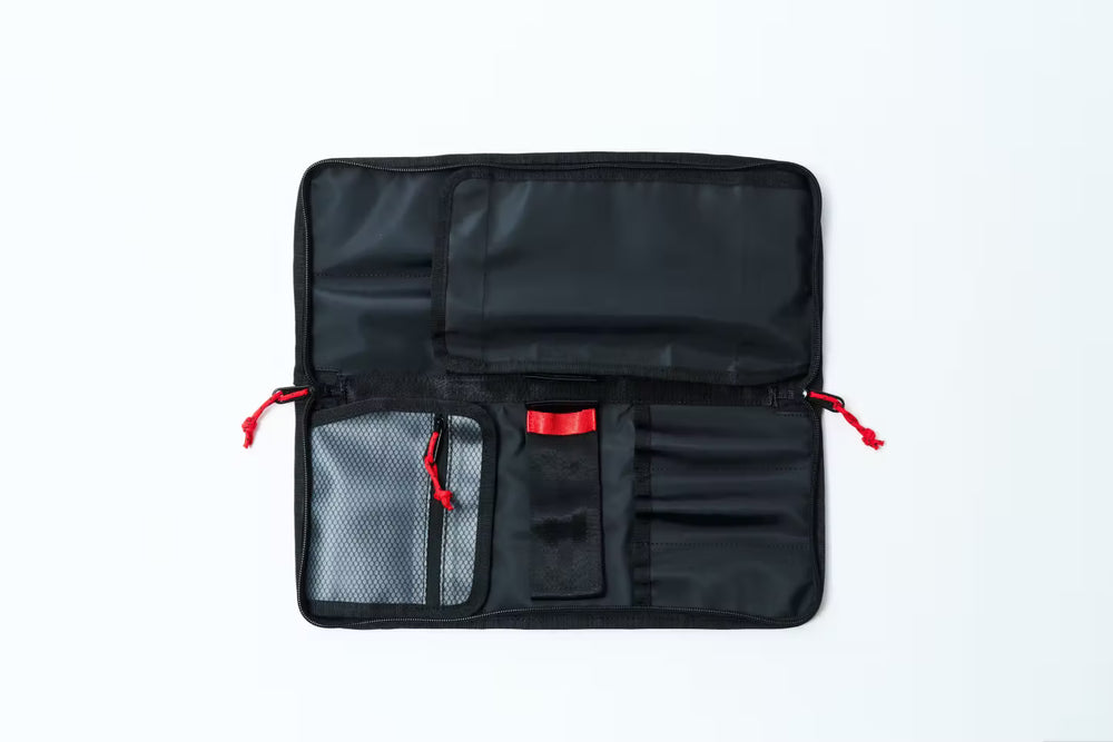 
                  
                    Black Knife bag with red zippers on a white background
                  
                