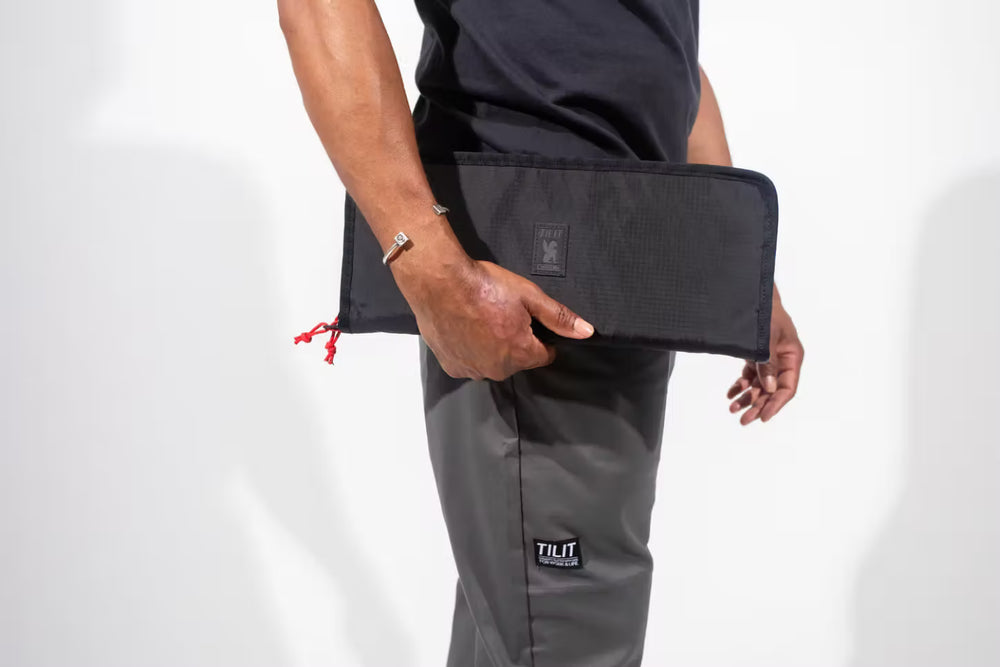 
                  
                    sling Knife bag in black with gray mesh with a red zipper
                  
                