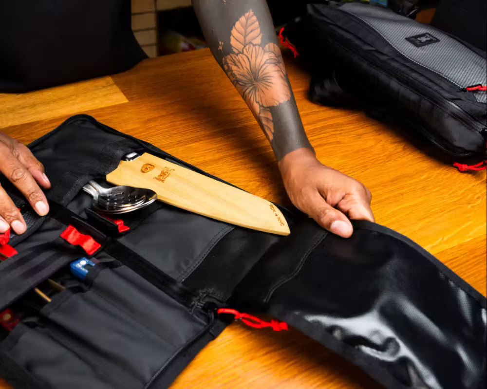 Black Knife bag with red zippers on a white background
